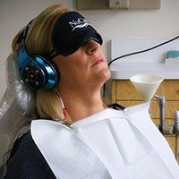 Patient with NuCalm facemask and headphones