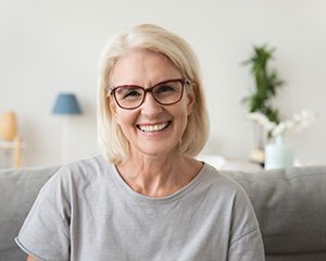 A smiling older woman enjoying her dental bridge